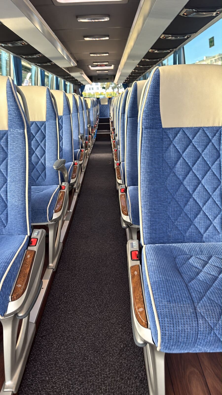 Inside the Mercedes-Benz Tourismo coach: rows of blue seats