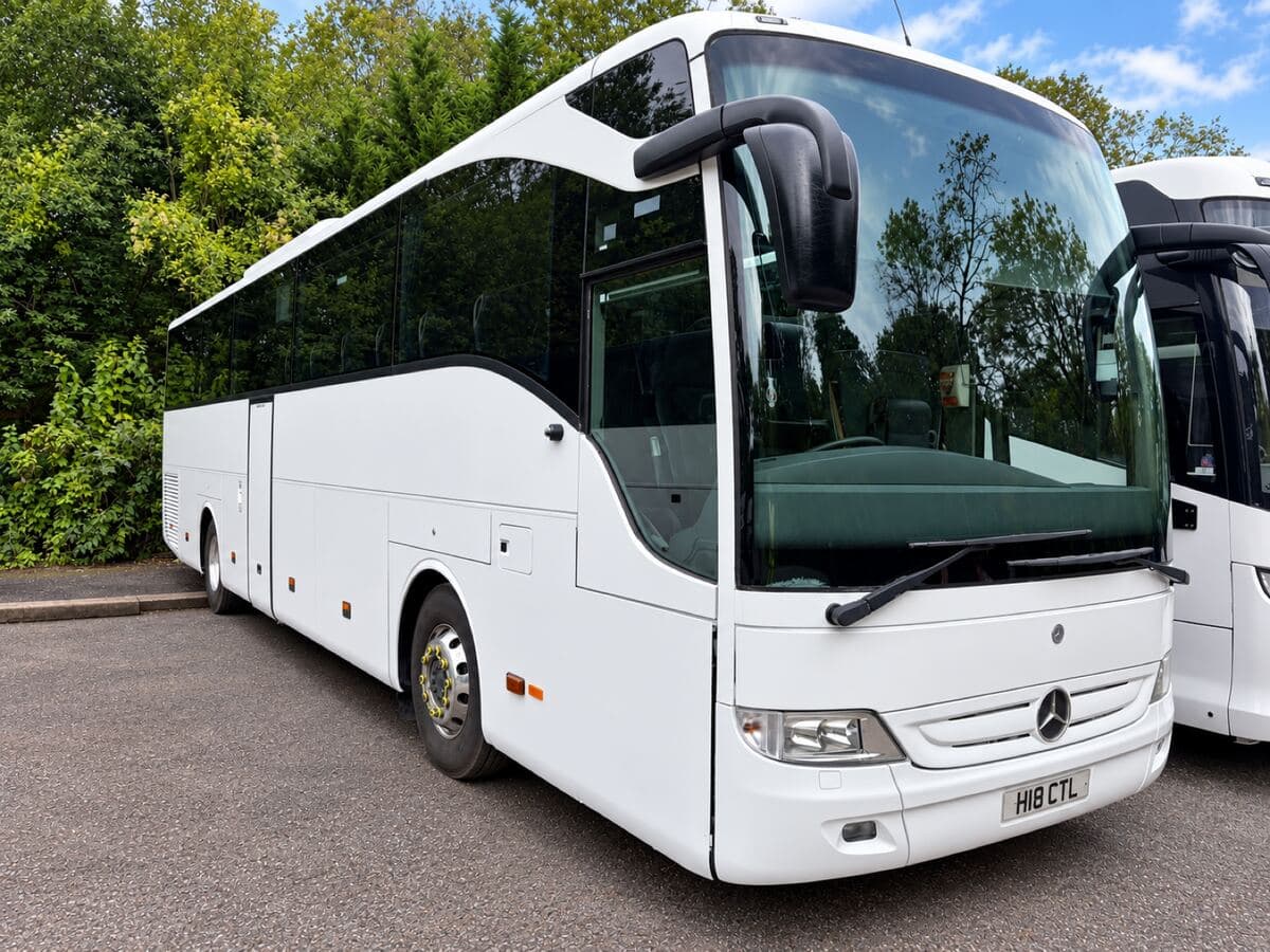 White Mercedes-Benz Tourismo coach from a partner operator